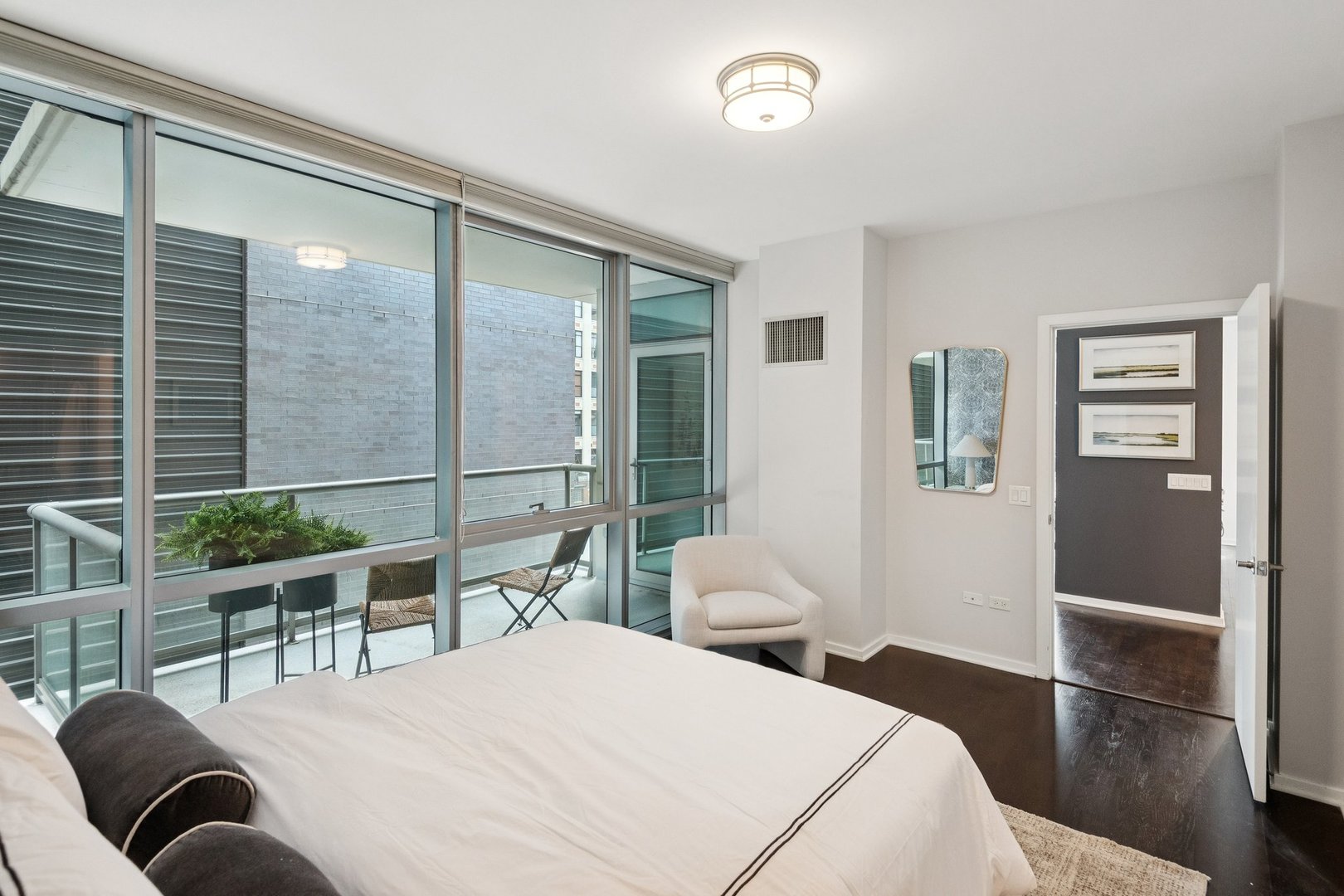 125 South Green Street, Unit 308A Chicago, IL 60607 - Photo 13 of 24 a bedroom with a bed and wooden floor