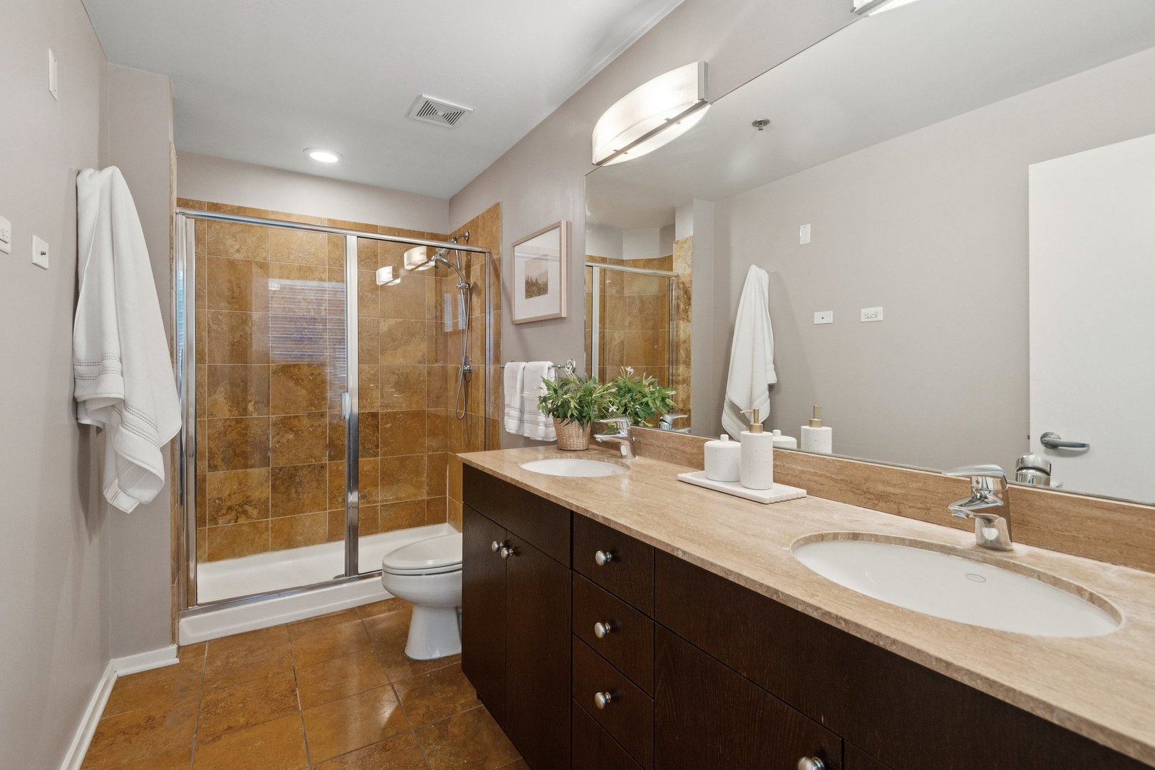 125 South Green Street, Unit 308A Chicago, IL 60607 - Photo 14 of 24 a bathroom with a double vanity sink toilet and shower
