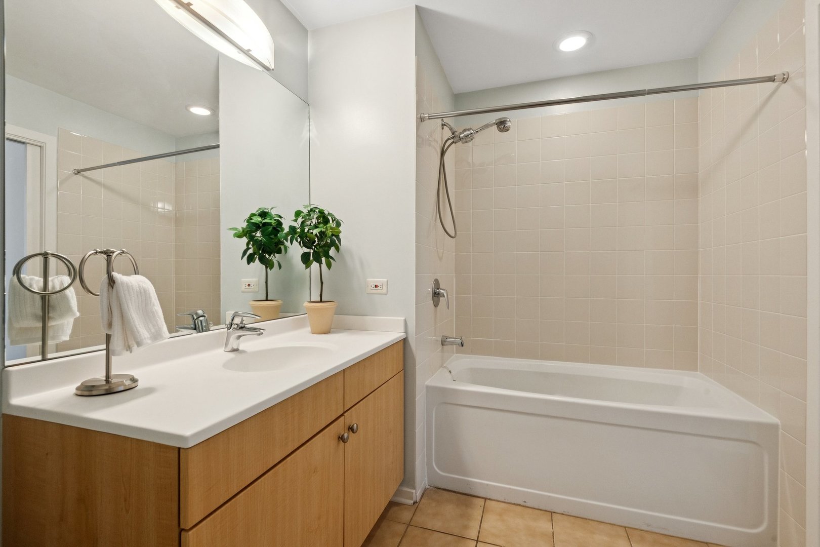 125 South Green Street, Unit 308A Chicago, IL 60607 - Photo 18 of 24 a bathroom with a sink and a mirror