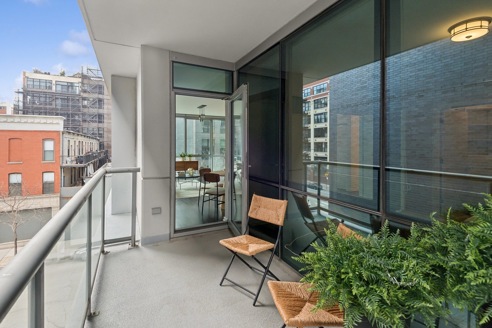 125 South Green Street, Unit 308A Chicago, IL 60607 - Photo 20 of 24 a balcony with chairs and a potted plant