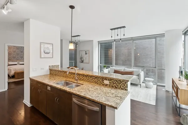 a living room with granite countertop furniture and wooden floor