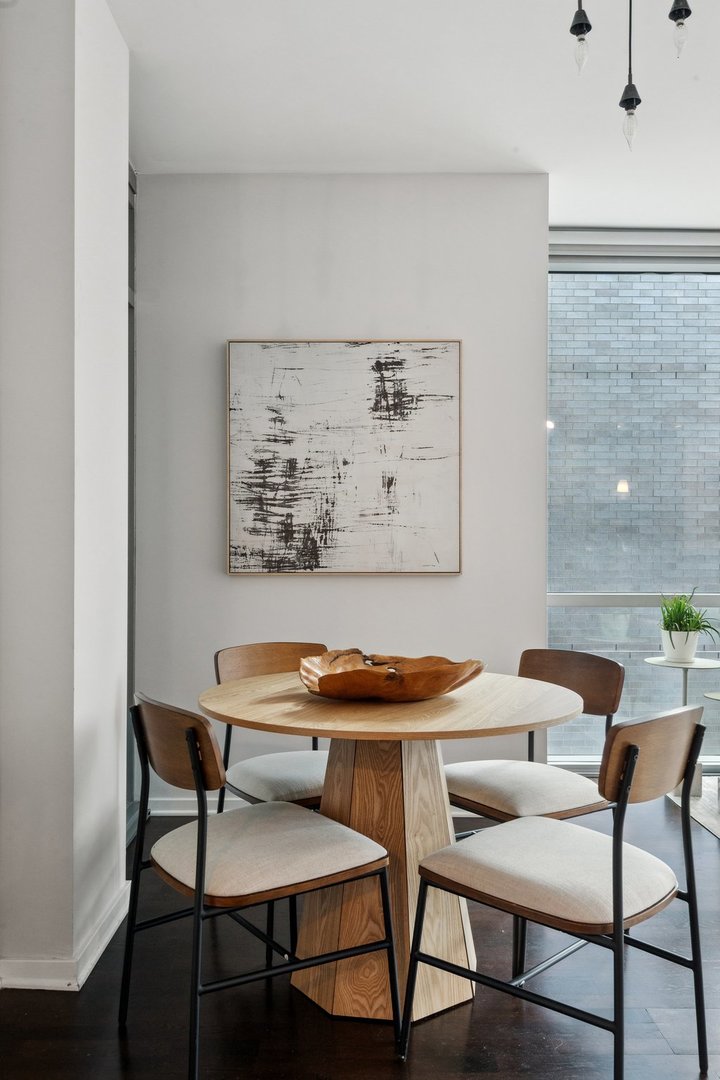 125 South Green Street, Unit 308A Chicago, IL 60607 - Photo 10 of 24 a view of a dining room with furniture and wooden floor