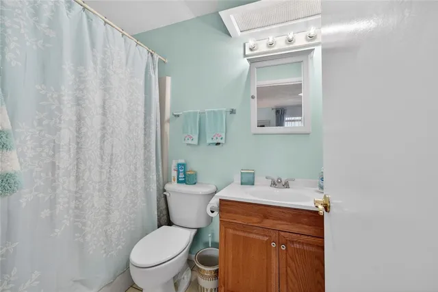 a white toilet sitting next to a bathroom sink