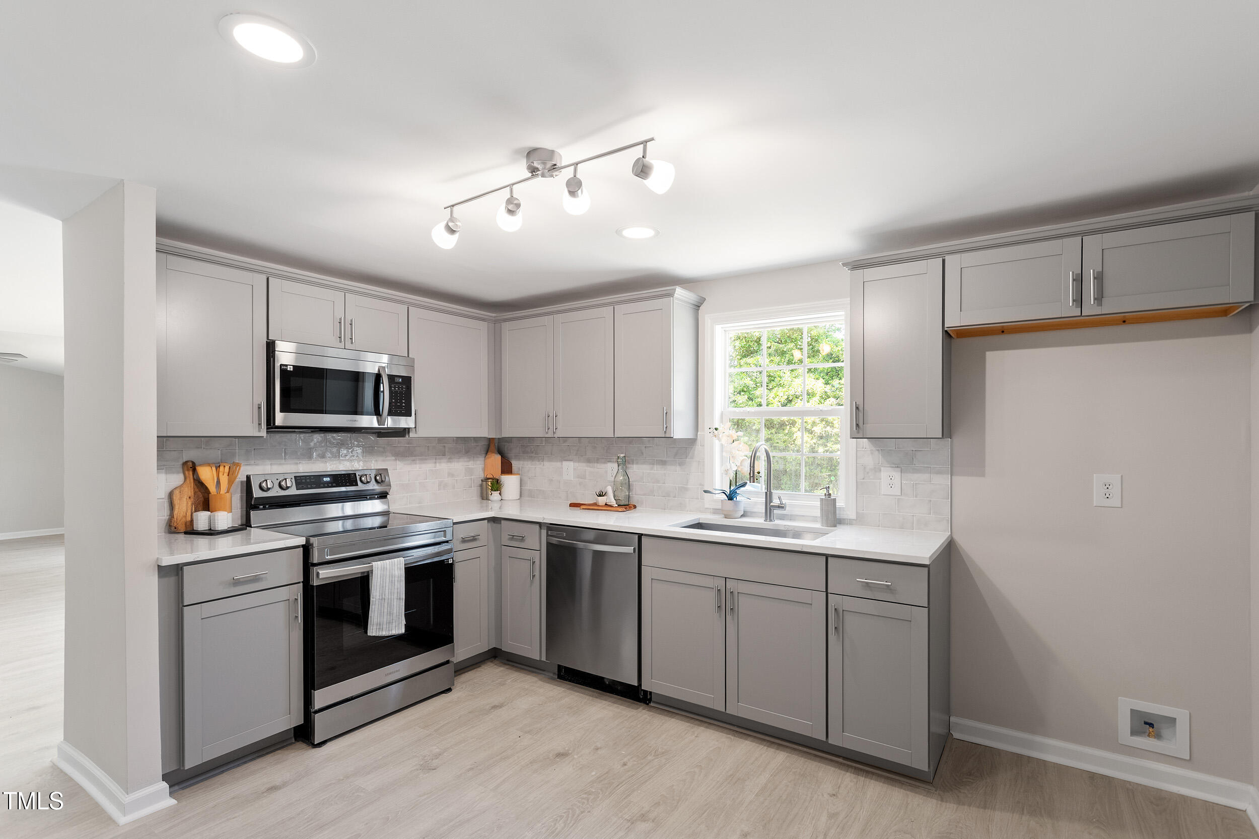 5049 West Hornes Church Road Bailey, NC 27807 - Photo 11 of 27 a kitchen with a sink stove cabinets and window