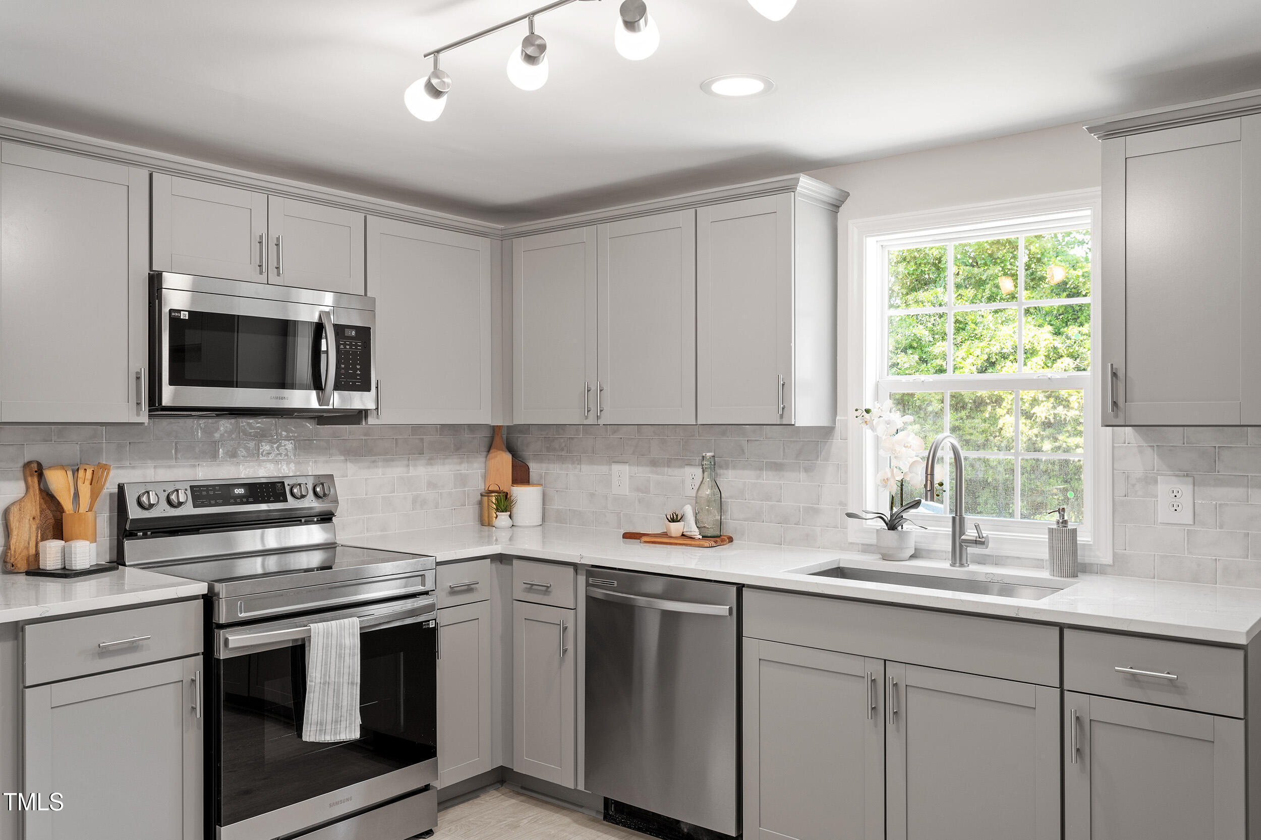 5049 West Hornes Church Road Bailey, NC 27807 - Photo 12 of 27 a kitchen with stainless steel appliances a sink a stove a microwave and cabinets