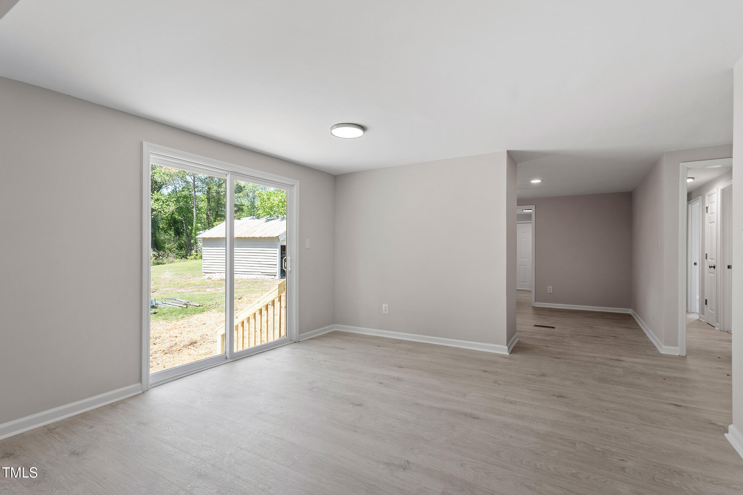 5049 West Hornes Church Road Bailey, NC 27807 - Photo 9 of 27 an empty room with large windows and garden view