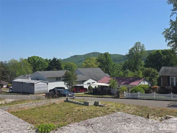 an aerial view of a house with garden space and trees
