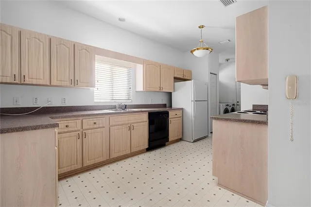a kitchen with a stove top oven sink and cabinets