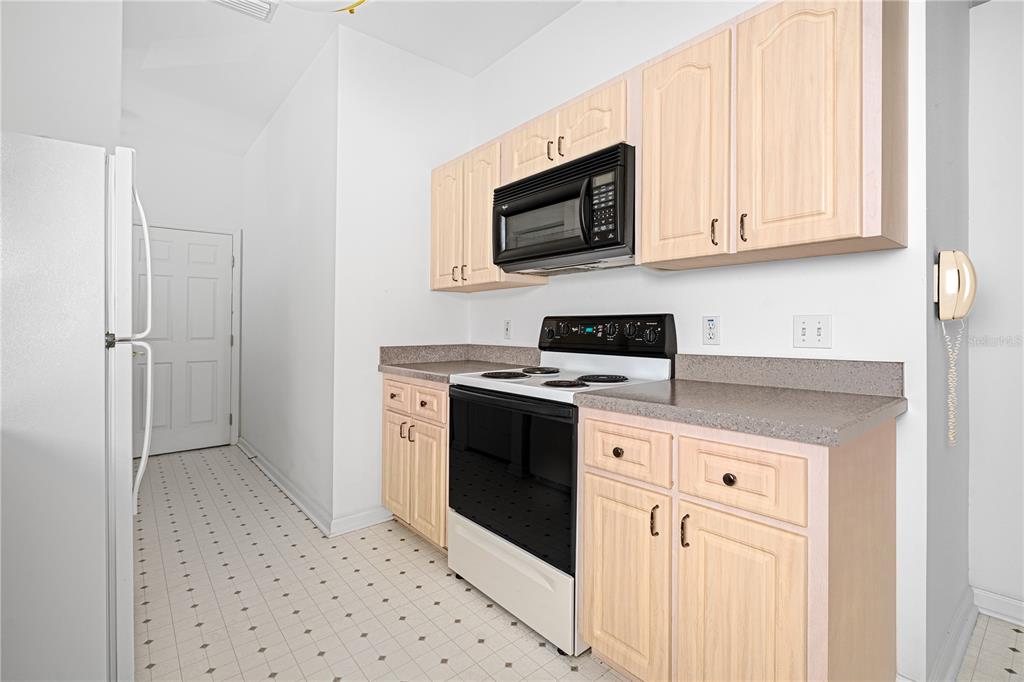 2459 Northwest 55th Avenue Road Ocala, FL 34482 - Photo 14 of 38 a kitchen with stainless steel appliances granite countertop a stove a microwave and a refrigerator