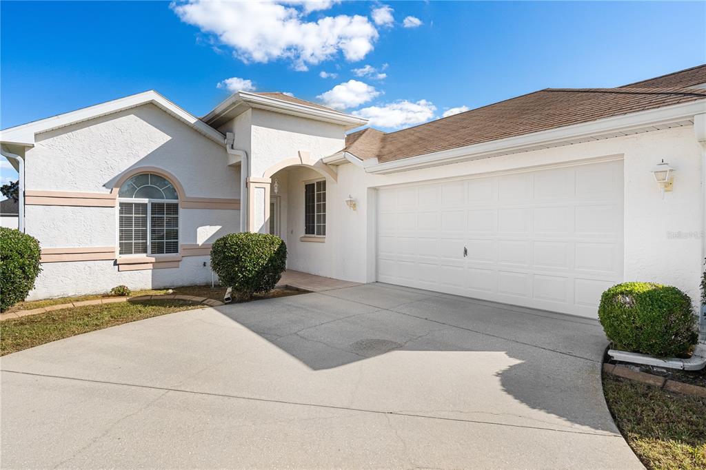 2459 Northwest 55th Avenue Road Ocala, FL 34482 - Photo 2 of 38 a view of a house with a large windows and plants