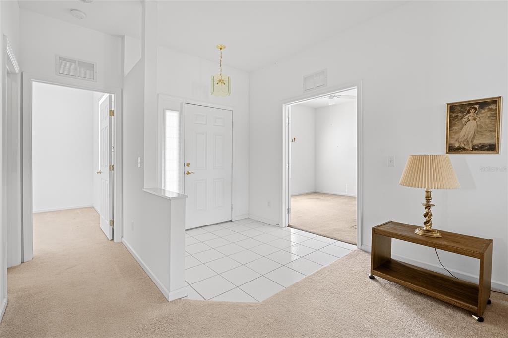 2459 Northwest 55th Avenue Road Ocala, FL 34482 - Photo 3 of 38 a spacious bedroom with a bed and a lamp