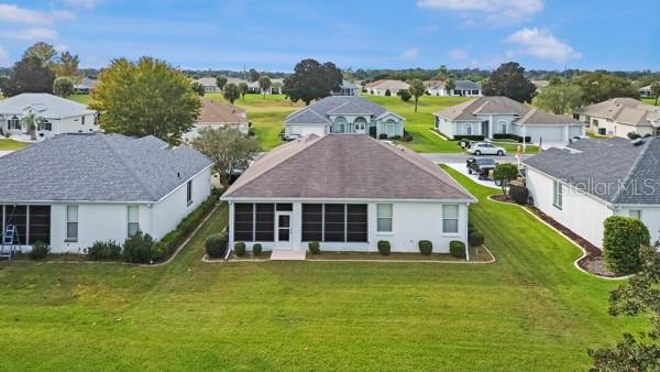2459 Northwest 55th Avenue Road Ocala, FL 34482 - Photo 33 of 38 a front view of a house with a garden and lake view