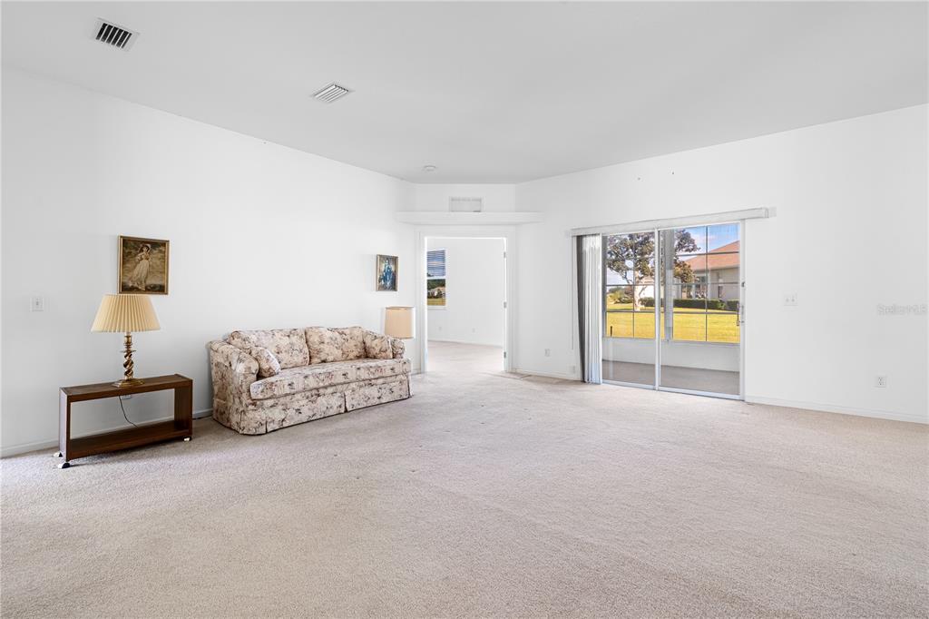 2459 Northwest 55th Avenue Road Ocala, FL 34482 - Photo 5 of 38 a spacious bedroom with a bed and a lamp