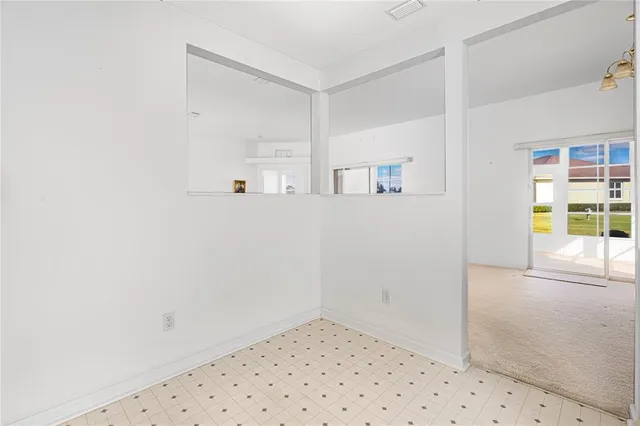 a kitchen with a sink a stove a refrigerator and white cabinets