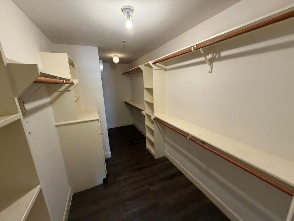 2710 Hullsmith Drive, Unit 701 Houston, TX 77063 - Photo 11 of 19 a view of closet with wooden floor
