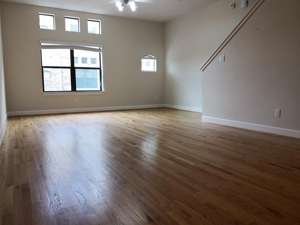 2710 Hullsmith Drive, Unit 701 Houston, TX 77063 - Photo 4 of 19 an empty room with wooden floor and windows