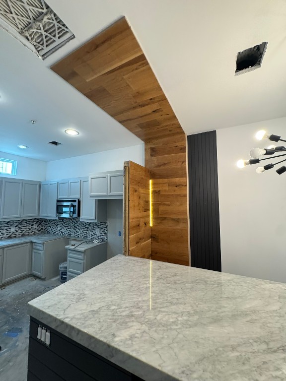 2710 Hullsmith Drive, Unit 701 Houston, TX 77063 - Photo 9 of 19 a kitchen with granite countertop wooden cabinets a sink and a stove