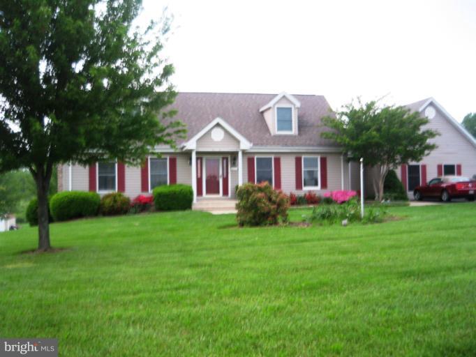 28731 Kemptown Road Mount Airy, MD 21771 - Photo 1 of 30 a front view of a house with a garden