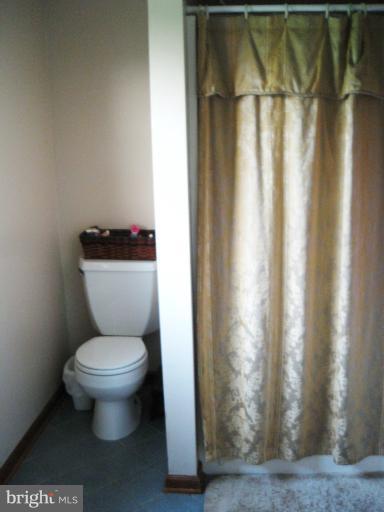 28731 Kemptown Road Mount Airy, MD 21771 - Photo 11 of 30 a white toilet sitting next to a shower