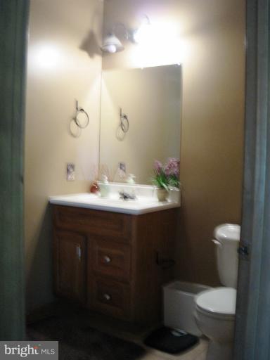 28731 Kemptown Road Mount Airy, MD 21771 - Photo 22 of 30 a bathroom with a sink a toilet and a mirror