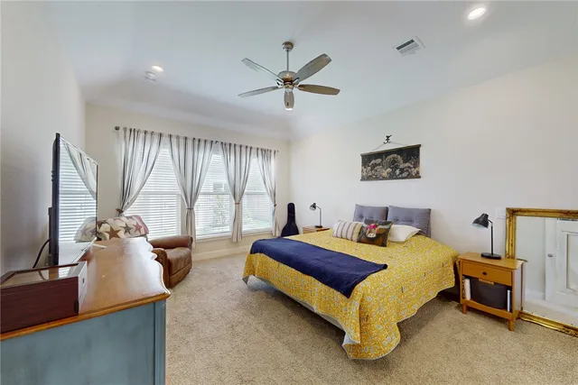 a bedroom with a bed and large mirror