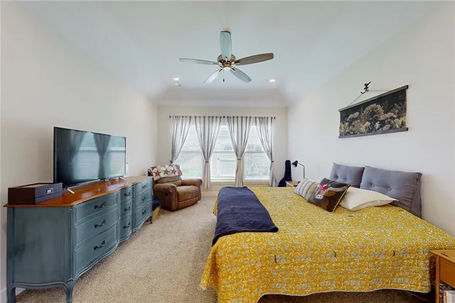 a bedroom with bed and windows