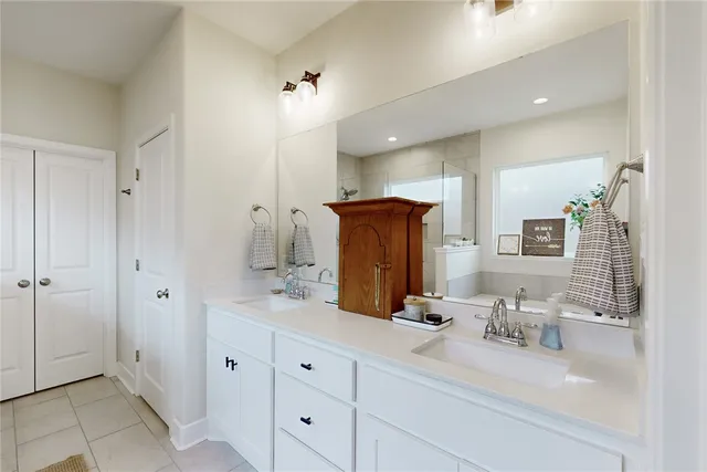 a bathroom with double vanity sink and a mirror