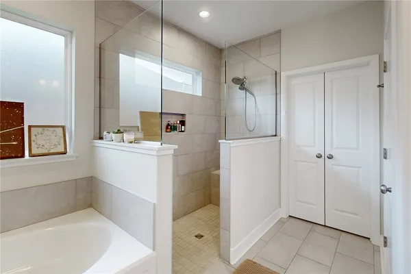 a bathroom with a bathtub a sink and a shower