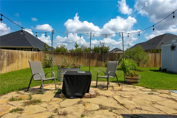 a view of a house with backyard porch and sitting area