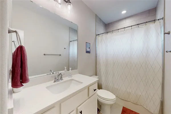 a bathroom with a sink toilet and shower