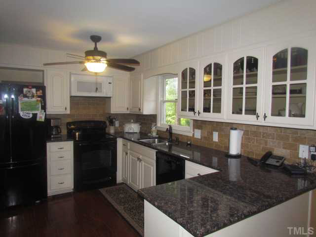 356 Shiloh Church Road Roxboro, NC 27574 - Photo 6 of 24 a kitchen with stainless steel appliances granite countertop a sink stove and refrigerator