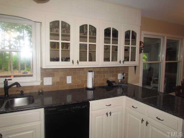 356 Shiloh Church Road Roxboro, NC 27574 - Photo 7 of 24 a kitchen with granite countertop a sink and a stove