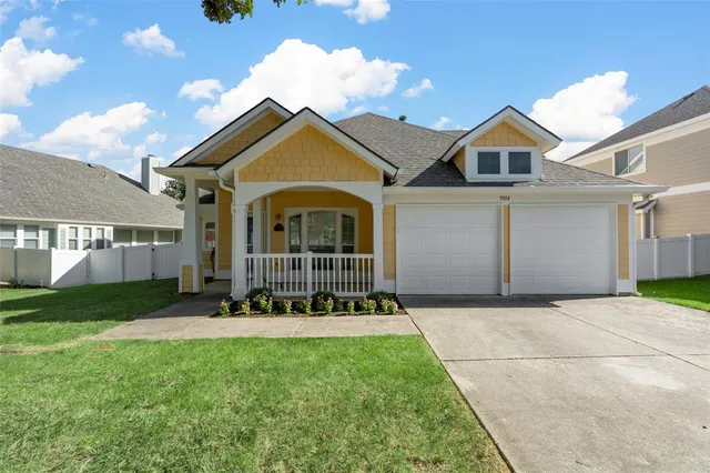 a front view of a house with a garden and yard