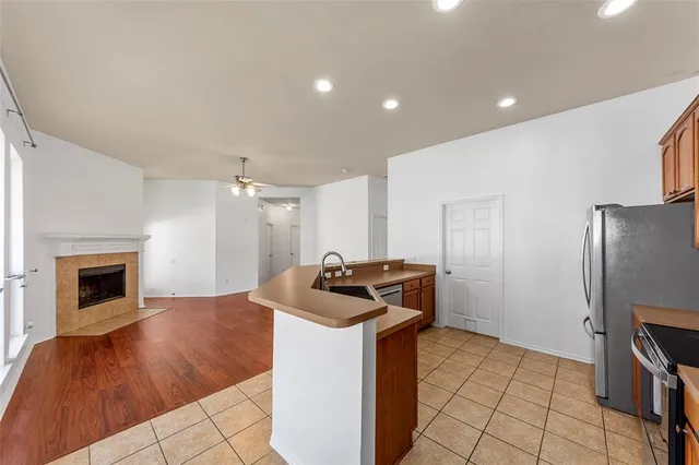 a kitchen with granite countertop a sink stove and refrigerator