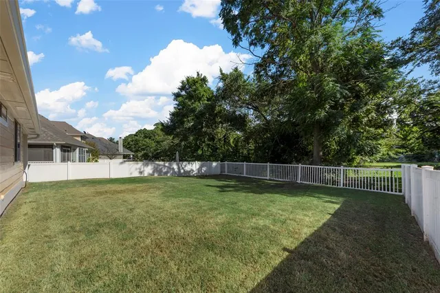 a view of an house with backyard space and garden