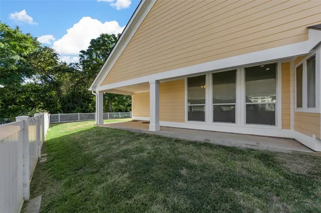 an aerial view of a house with a yard table and chairs