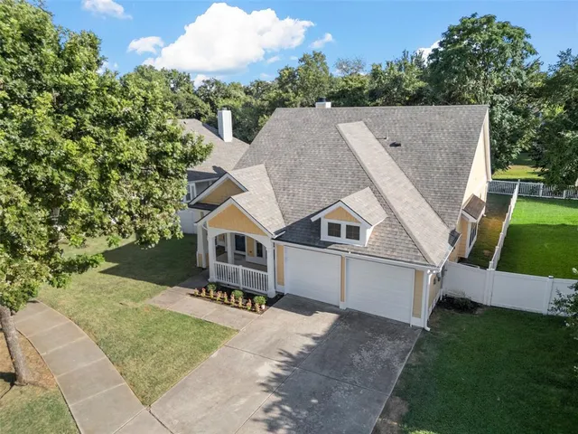 an aerial view of a house with a yard and outdoor seating