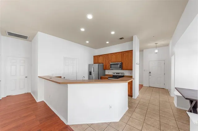 a kitchen with stainless steel appliances a sink stove and cabinets