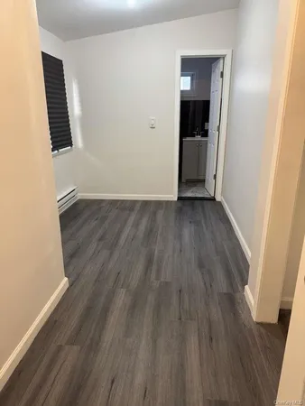 an empty room with wooden floor