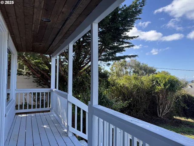 a view of a balcony with wooden floor