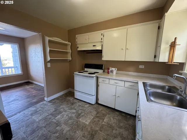 a kitchen with cabinets and white appliances
