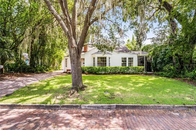 a front view of house with yard and green space