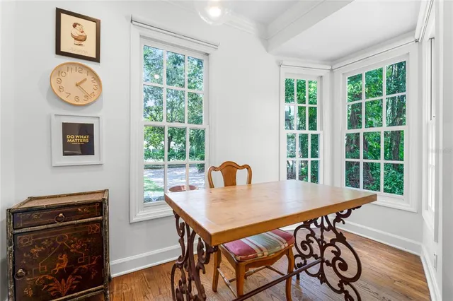 a view of a dining room with furniture window and wooden floor