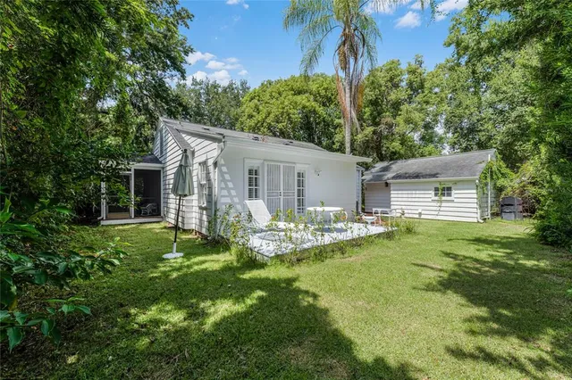 a view of an house with backyard space and garden