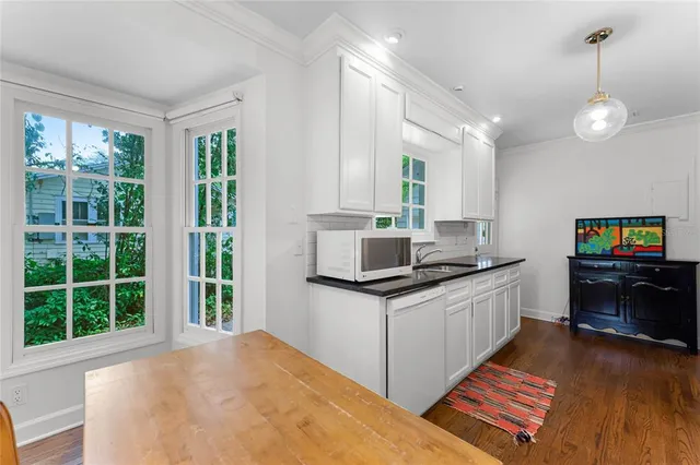 a kitchen with stainless steel appliances granite countertop a stove and a wooden floors