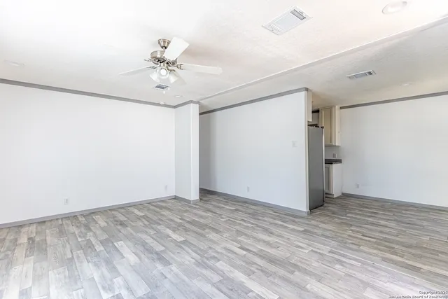 wooden floor in an empty room with a window