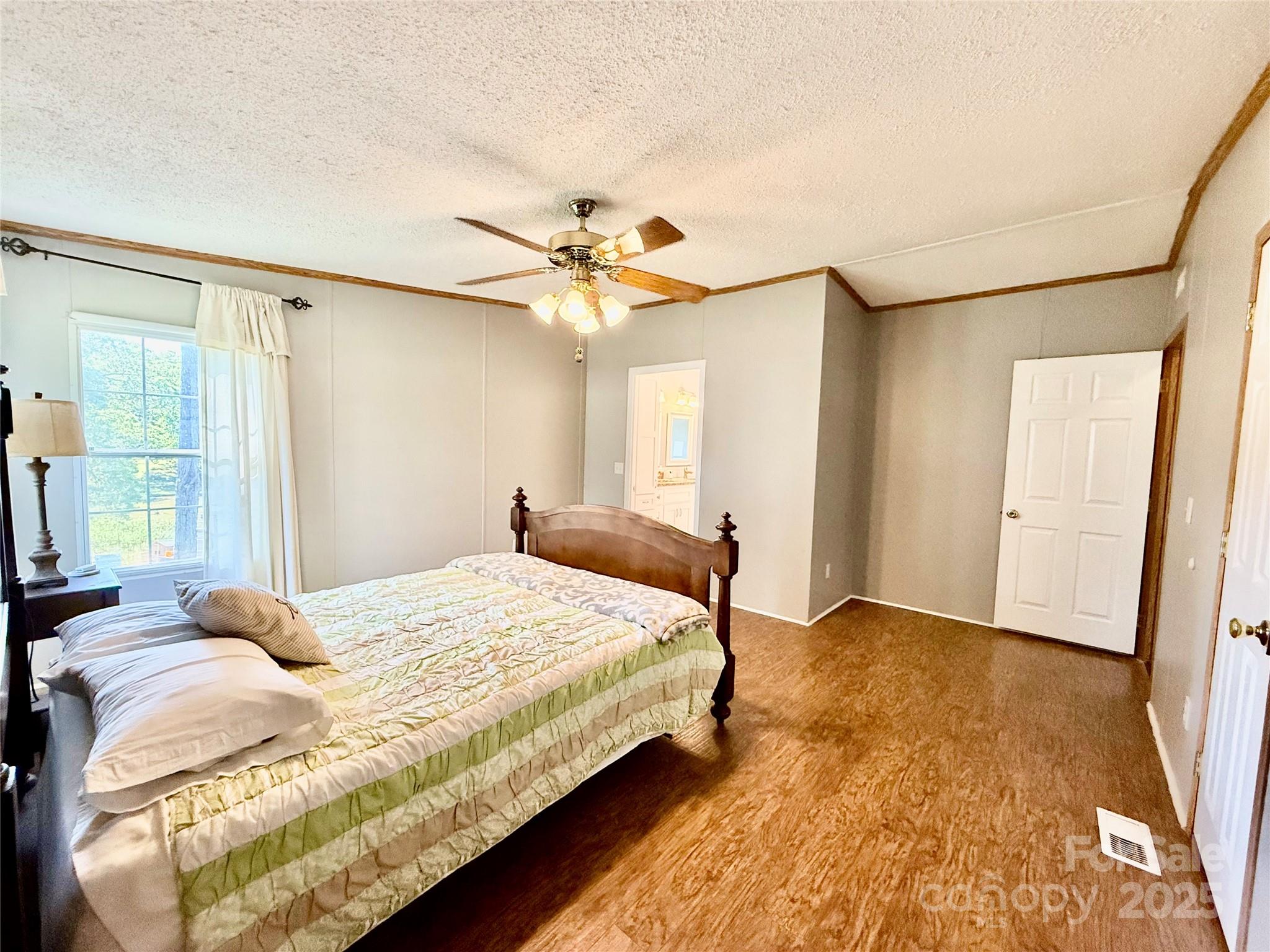 37 Suede Lane Ridgeway, SC 29130 - Photo 19 of 42 a bedroom with a bed and a chandelier