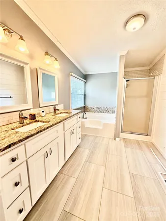 a spacious bathroom with a sink double vanity and a mirror