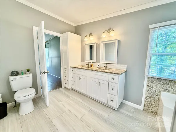 a bathroom with a bathtub and a window