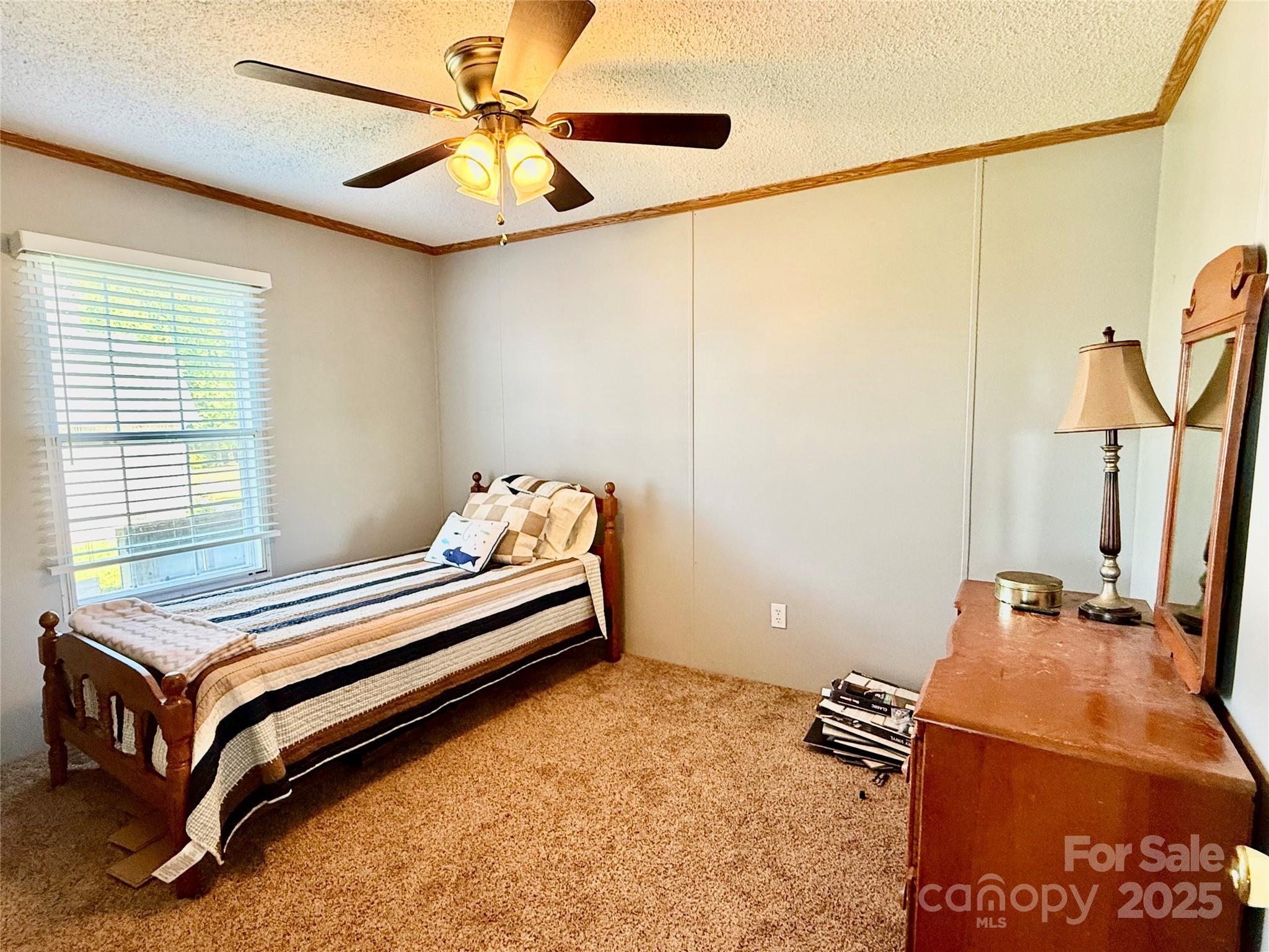 37 Suede Lane Ridgeway, SC 29130 - Photo 25 of 42 a bedroom with a bed and a chandelier